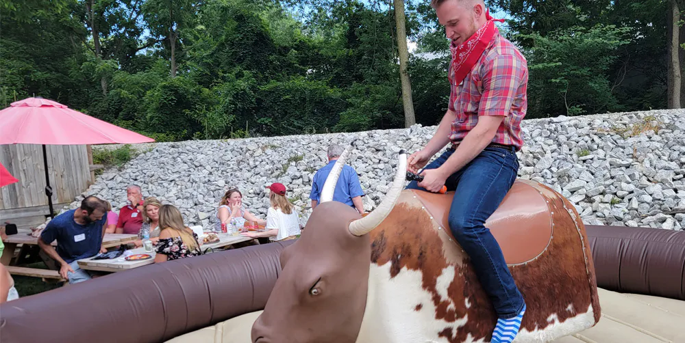 A company picnic with a mechanical bull ride run by INDY Event Team